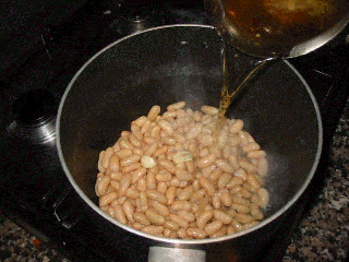 making creamy white beans soup with shrimps